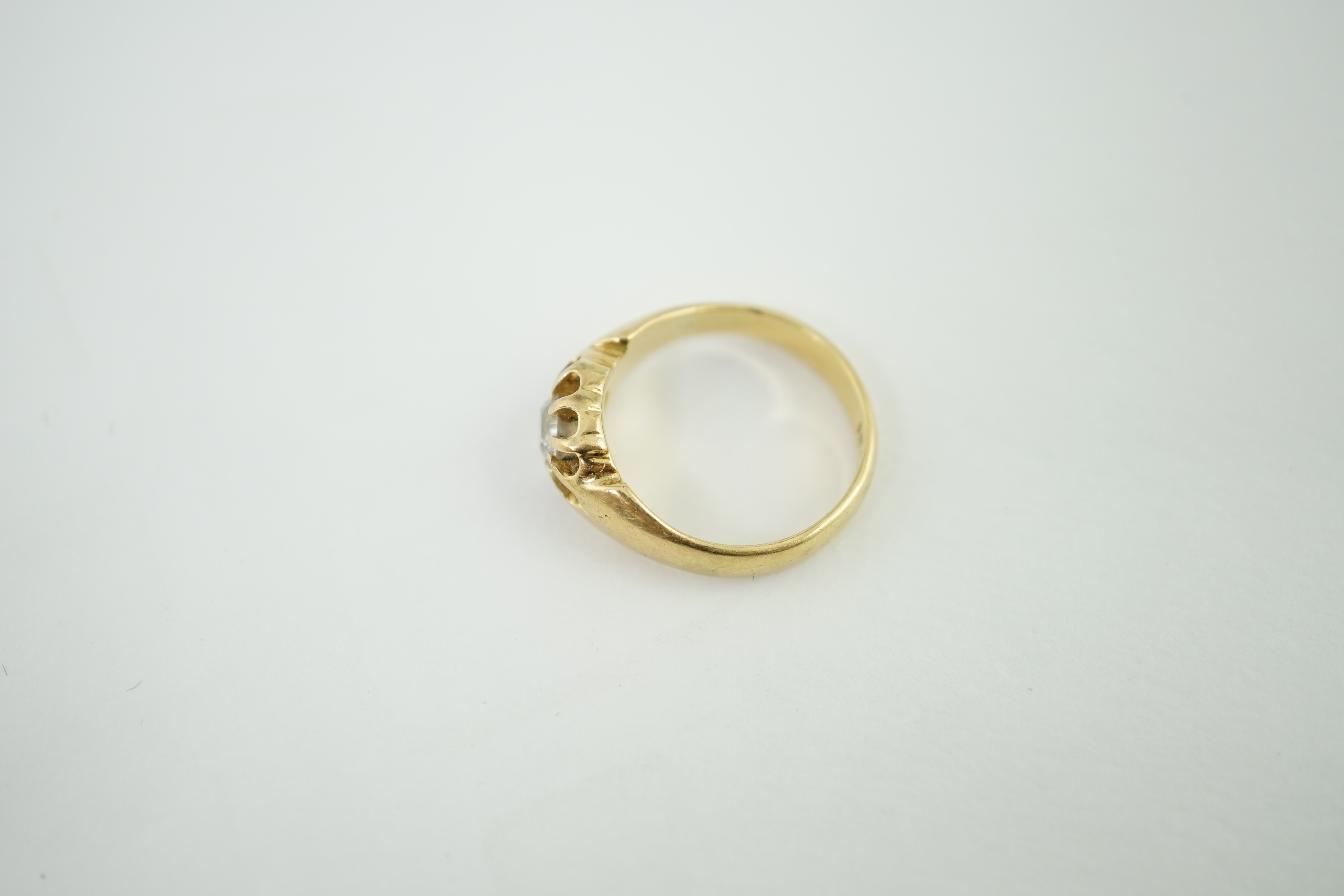 An early 20th century 18ct gold and claw set solitaire diamond ring